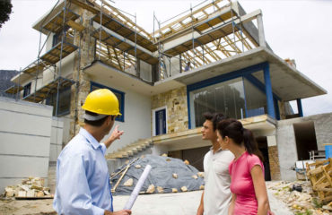 Contractor discussing with client the status of their home that is under construction